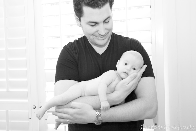 Baby girl in fathers arms - baby portrait photography sydney